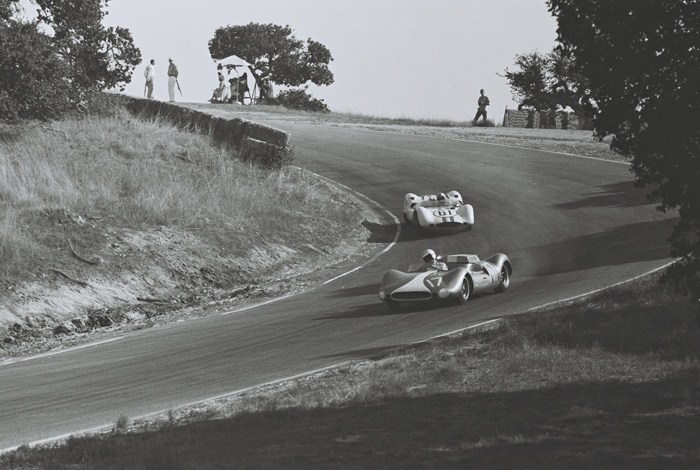 Walt Hansgen dropping back in the pack as he develops car troubles and Roger Penske takes him in the Corkscrew
